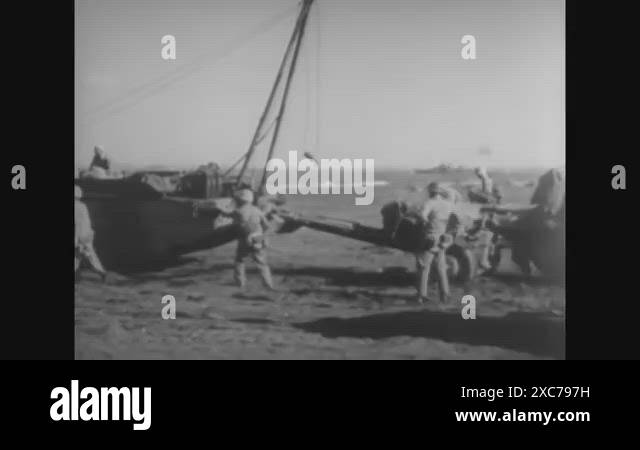 1945 - Various scenes of marines moving artillery on the beach of Iwo ...