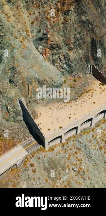 Cars moving by the dangerous road in the mountains of pacific shore ...