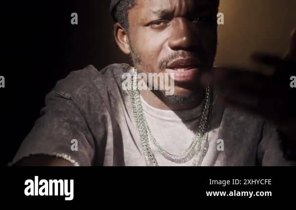 Chest up of cool African American guy wearing backwards cap and set of ...