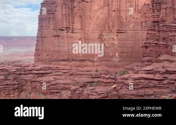 A slow tilt up a towering cliff face at Fisher Towers in Moab, Utah. A ...