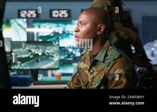 Intelligence operative in military base doing surveillance with digital ...