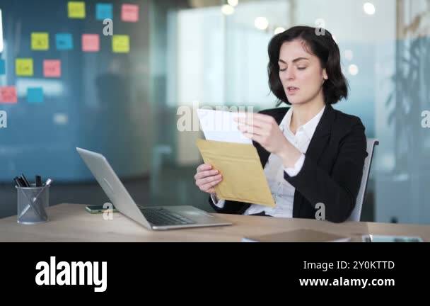Professional woman in office reading letter with bad news, showing ...