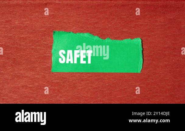 Safety first message writing on ripped torn green paper on brown ...