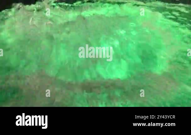 Close-up water bubbling in jacuzzi spa in swimming pool. Alluring green ...