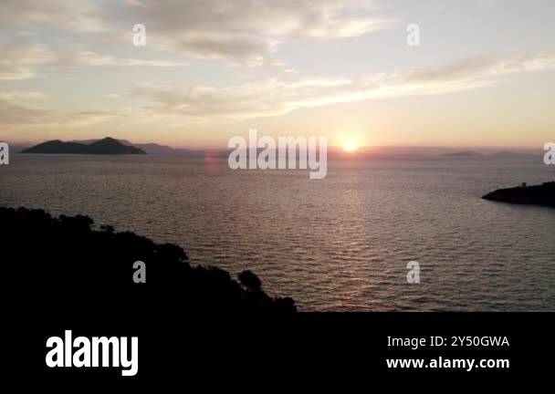 Sun rising from the sea. Colorful cloudy sky and sunbeams. Sunrise over ...