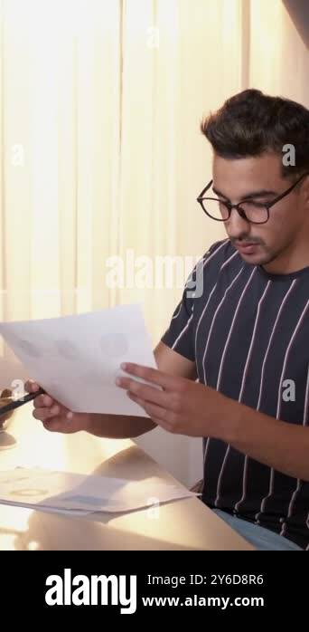 Papers Checking Graphics Vertical video. Work report. Business accounting. Concentrated busy man ...