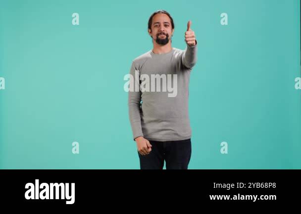 Portrait of upbeat man showing thumbs up sign gesturing, exulting happy ...