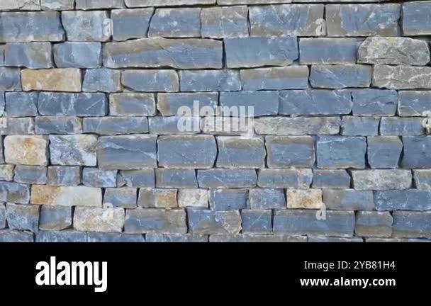 Modern gray brown, beige, metal door at the house lined with stone ...