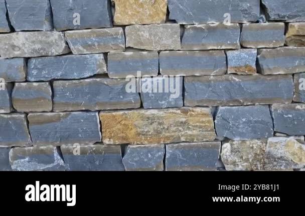 Modern gray brown, beige, metal door at the house lined with stone ...