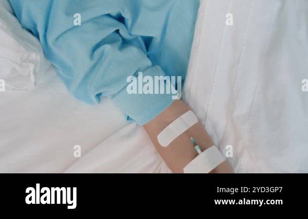 Tilt shot of sleeping Caucasian girl with nasal cannula lying in ...