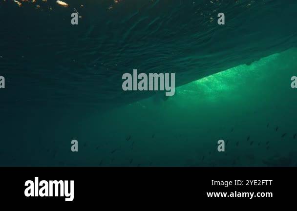 Underwater view of the ocean wave breaking on the shore in the Maldives ...