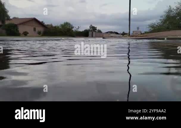 Aftermath of overnight rain fall flooding streets in North-West Phoenix ...