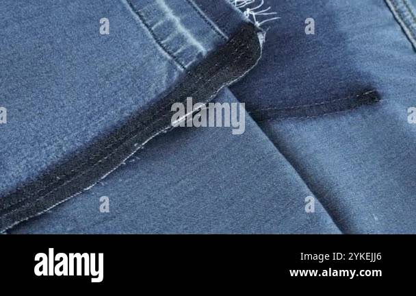 Flip Rotation Textiles Soft folds of blue denim of a muted shade fabric rotate on the showcase ...