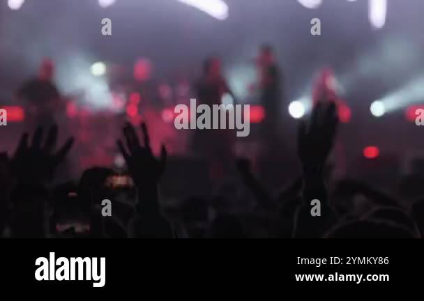 On Stage Back View Rapper Back view real time of band performing on stage with glowing spotlights ...