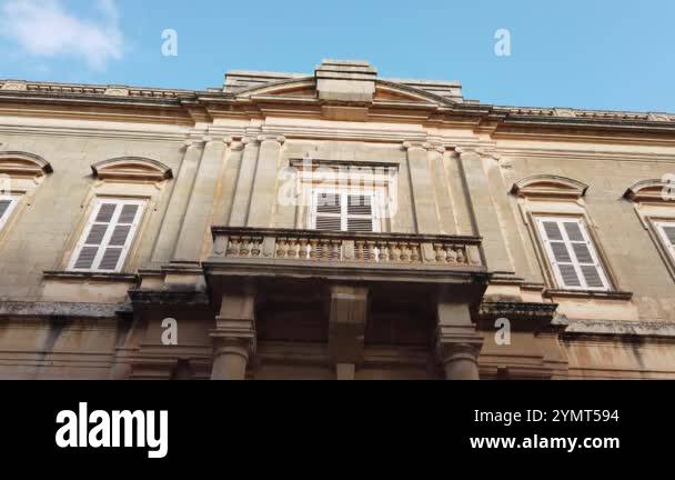 Traditional facade of an old authentic building with red doors on the ...