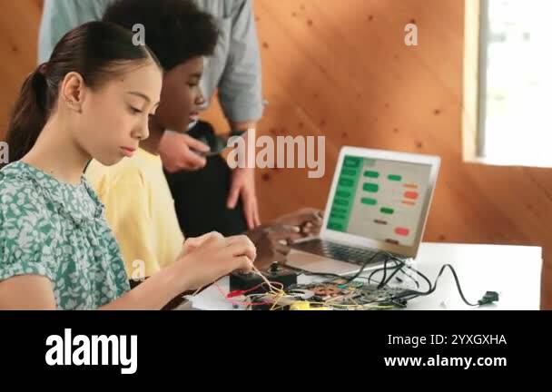Teacher standing while explain coding and robotic construction. Diverse ...
