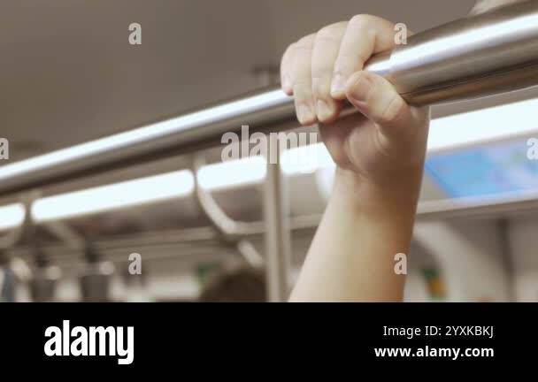 Hand Rails Subway Close up view with selective focus of a looped handle handrails hold in ...