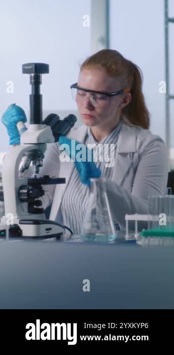Medical science lab: Female microbiologist takes liquid from test tube ...
