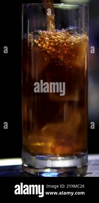 Fresh Cola Being Poured In To The Glass With Ice Cubes On White ...