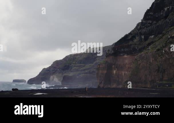 Stunning rocky coastal cliffs of Portugal under an overcast sky create ...