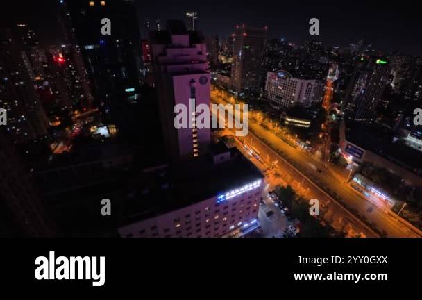 A vibrant city skyline comes alive at night with bright lights ...