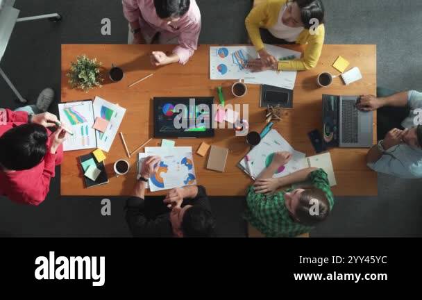 Top view of smart team putting hands together while looking at ...
