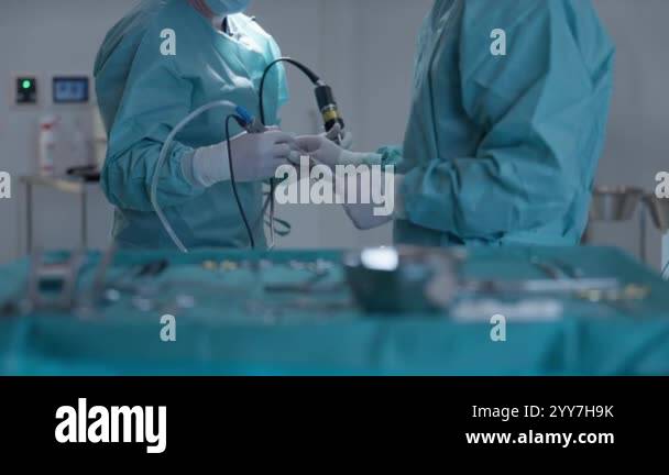 Surgeons Operating Process Close-up of surgeons performing a minimally invasive procedure with ...