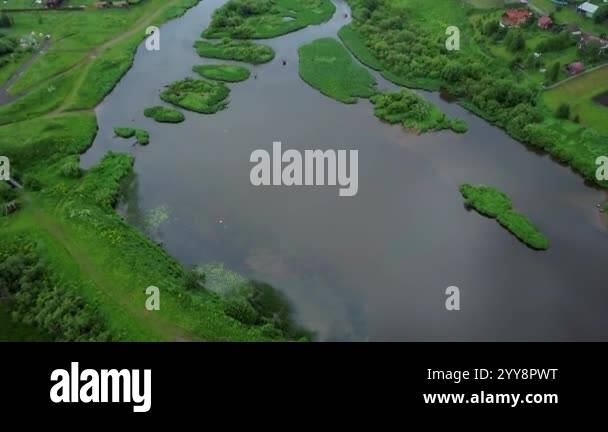 This stunning aerial capture showcases a winding river gracefully ...