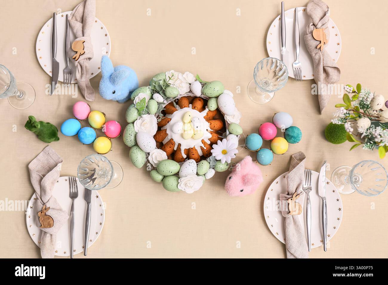 Table setting with Easter cake, painted eggs and flowers, top view Stock Photo