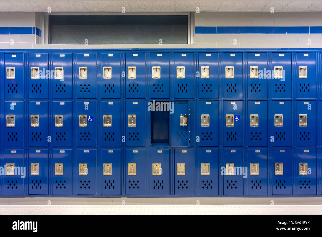 Empty team locker room, changing room, with an open locker, with traditional blue metal lockers. Stock Photo