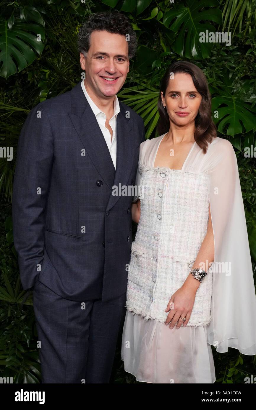 Felicity Guard Charles Guard, left, and Felicity Jones arrive at Chanel's 16th Annual ...