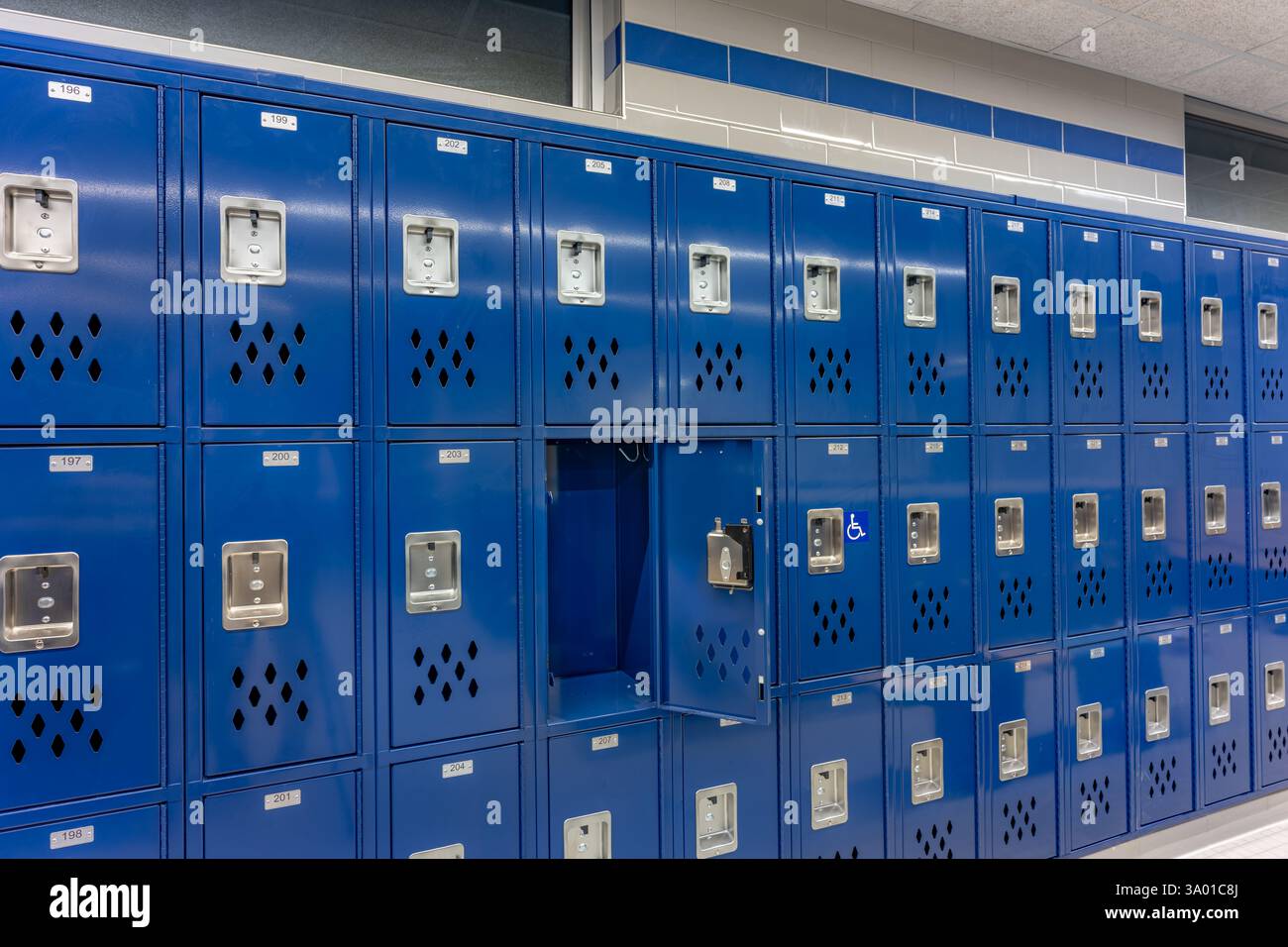 Empty team locker room, changing room, with an open locker, with traditional blue metal lockers. Stock Photo