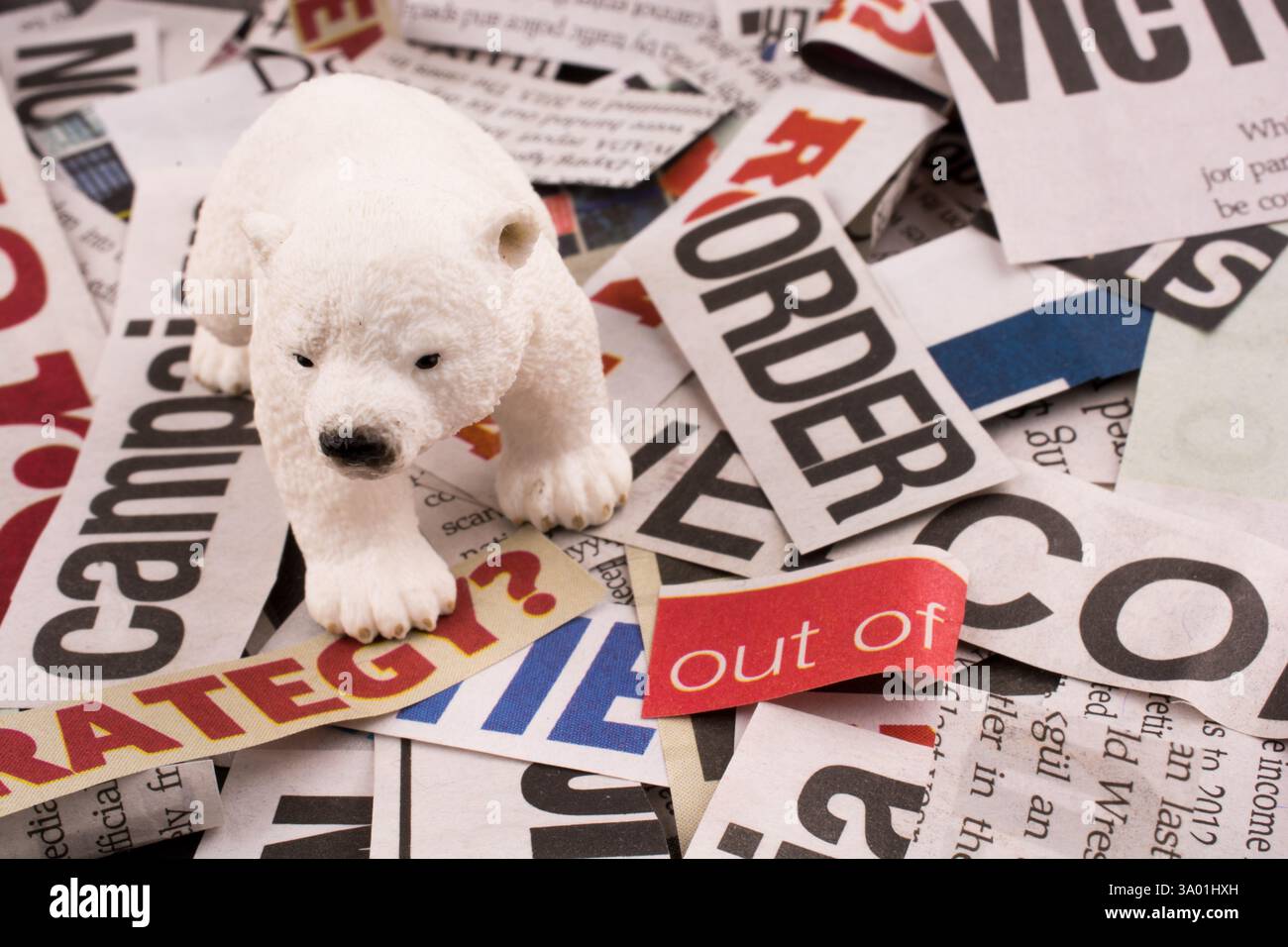 Polar bear on cut newspaper titles Stock Photo