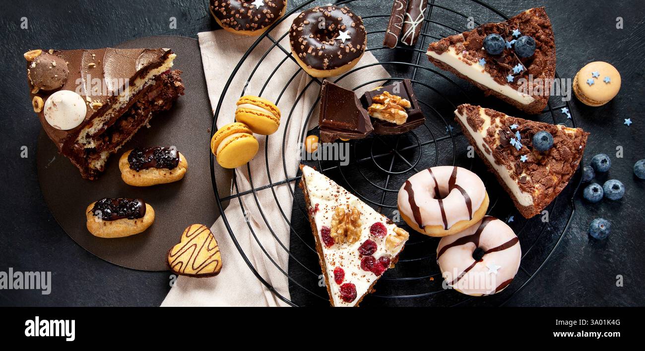 Table with various cookies, donuts, cakes, cheesecakes Stock Photo
