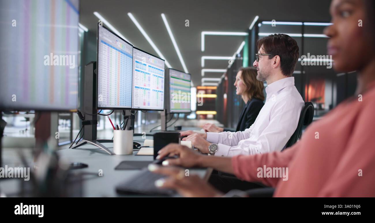 Team of diverse professionals using software to create billing reports Stock Photo