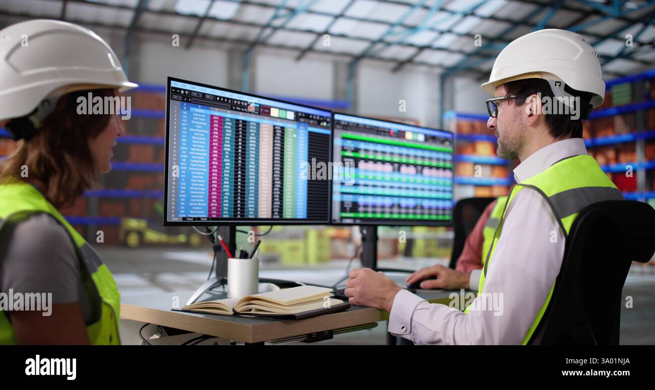 The Manager Analyzing Data on His Desktop in the Warehouse Stock Photo