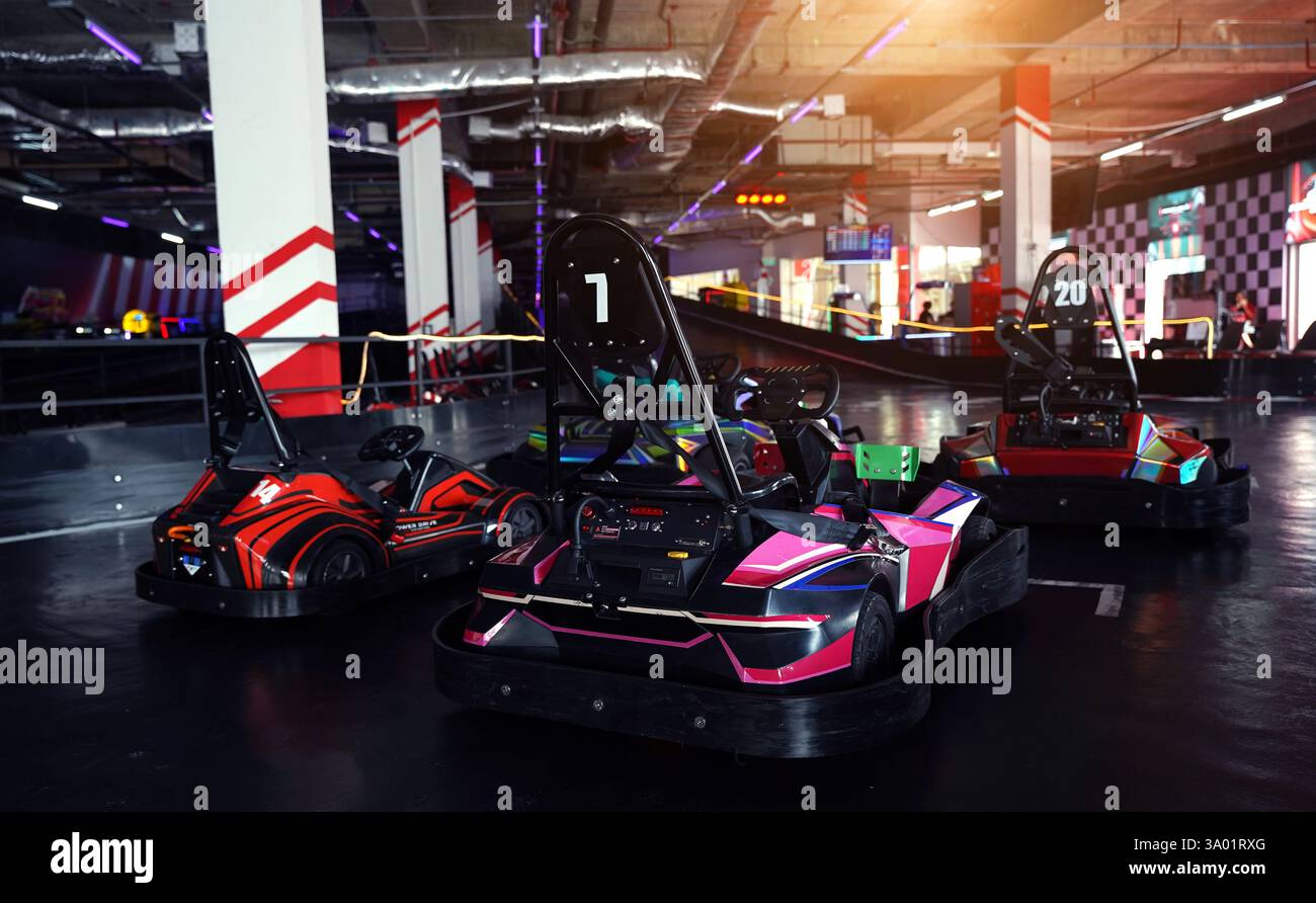 New electric go karts in the modern indoor racing track Stock Photo - Alamy