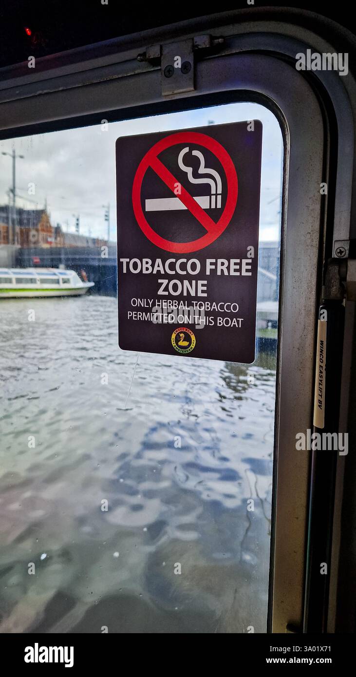 Amsterdam, Netherlands - December 3,  2024: Sign with text 'Tobacco free zone. Only herbal tobacco permitted on this boat.' - Smartphone Captured Stock Image