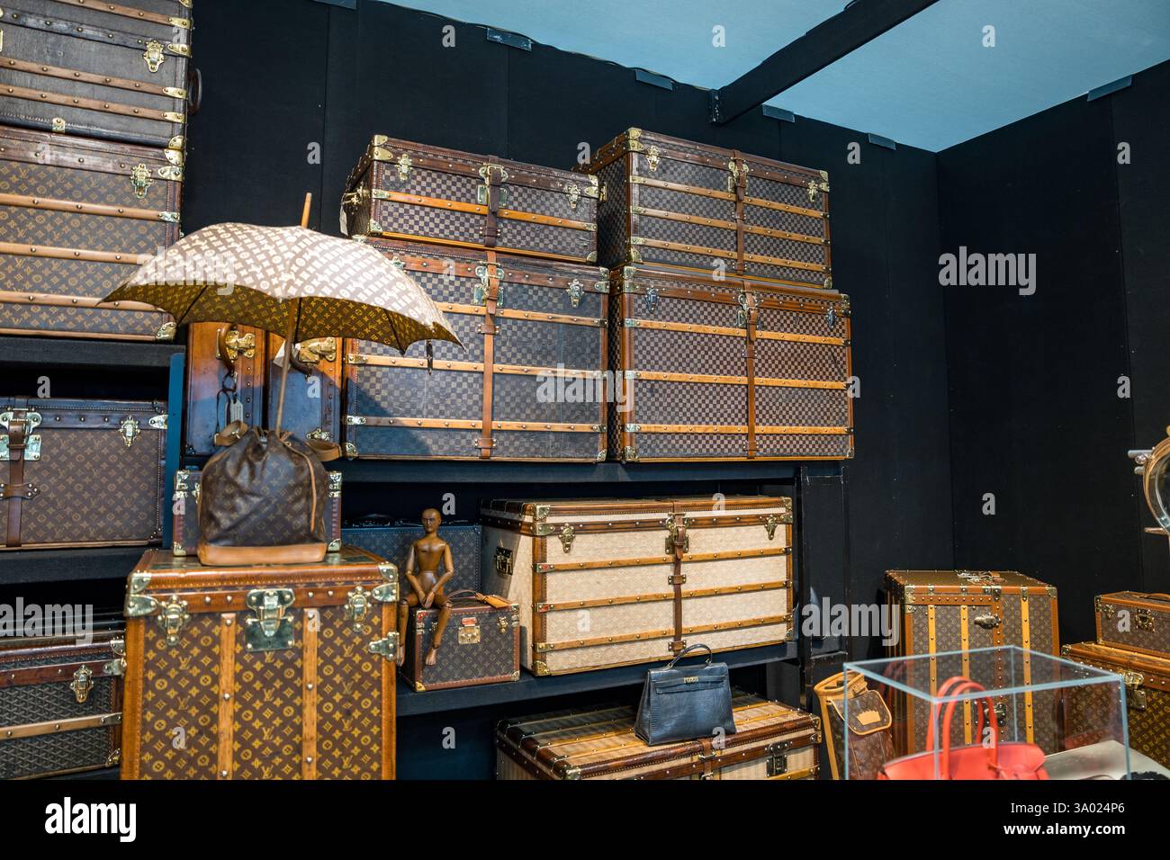 Luxurious vintage luggage collection displayed in a chic boutique, revealing craftsmanship and elegance of travel accessories Stock Photo