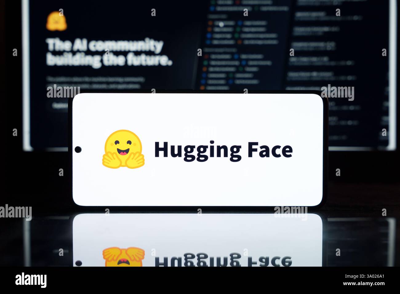 Hugging Face AI logo with a smiling face icon on a smartphone screen ...
