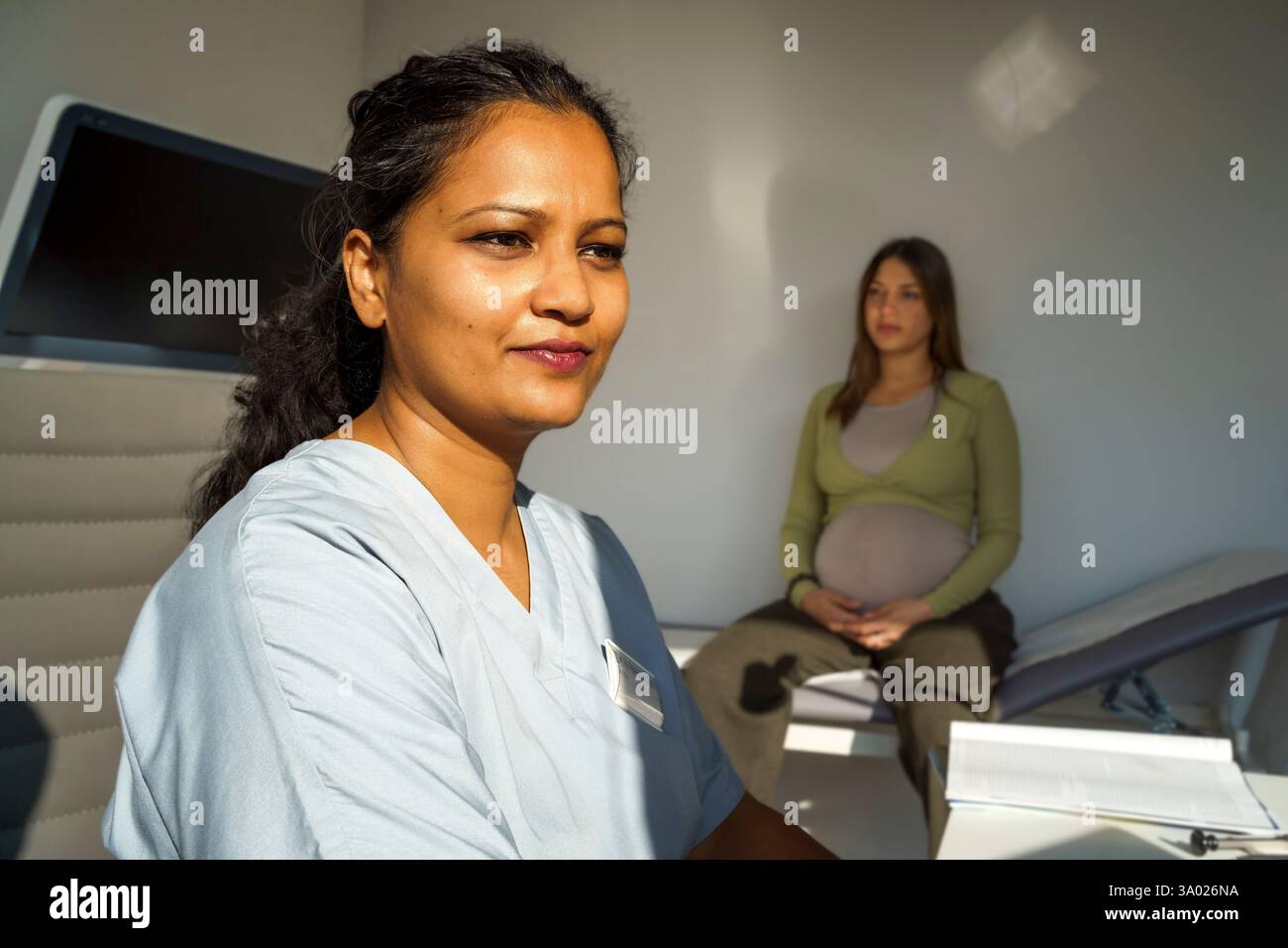 Female obstetrician doing medical exam of pregnant woman during visit ...