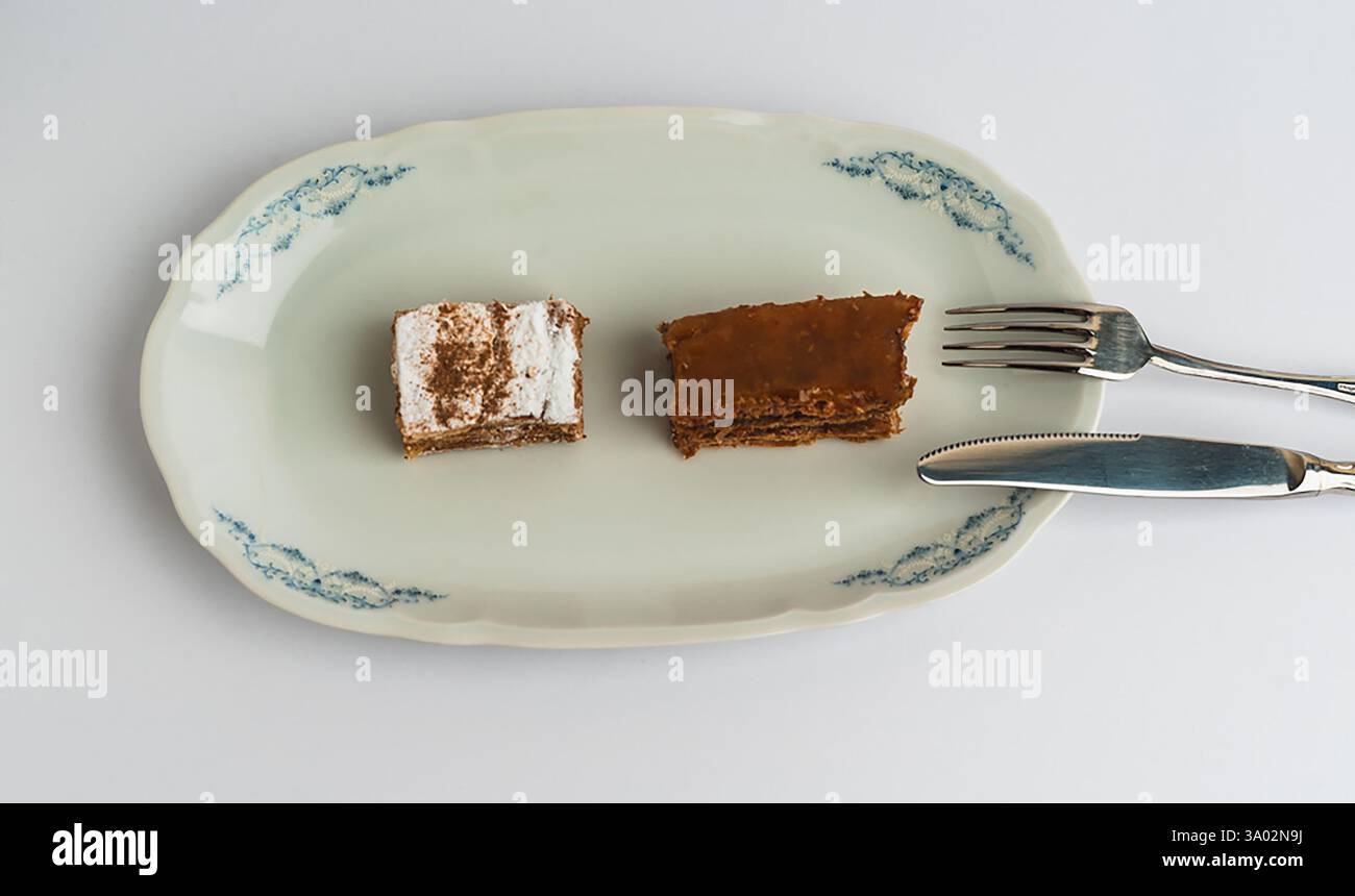 Delicious dessert platter featuring layers of cake and creamy frosting served on an elegant plate Stock Photo