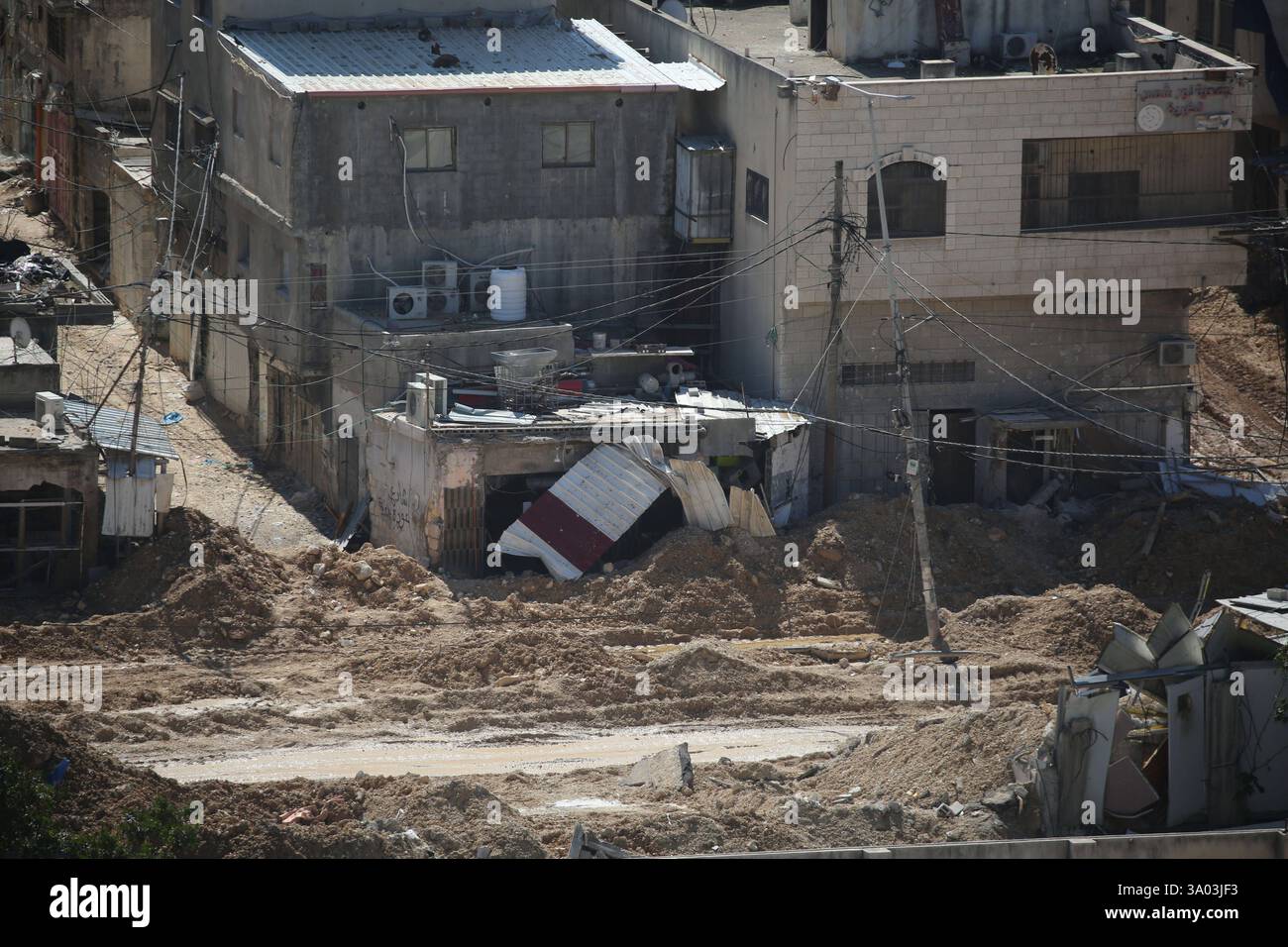 An Israeli military bulldozer demolishes Palestinian homes in the Nur ...