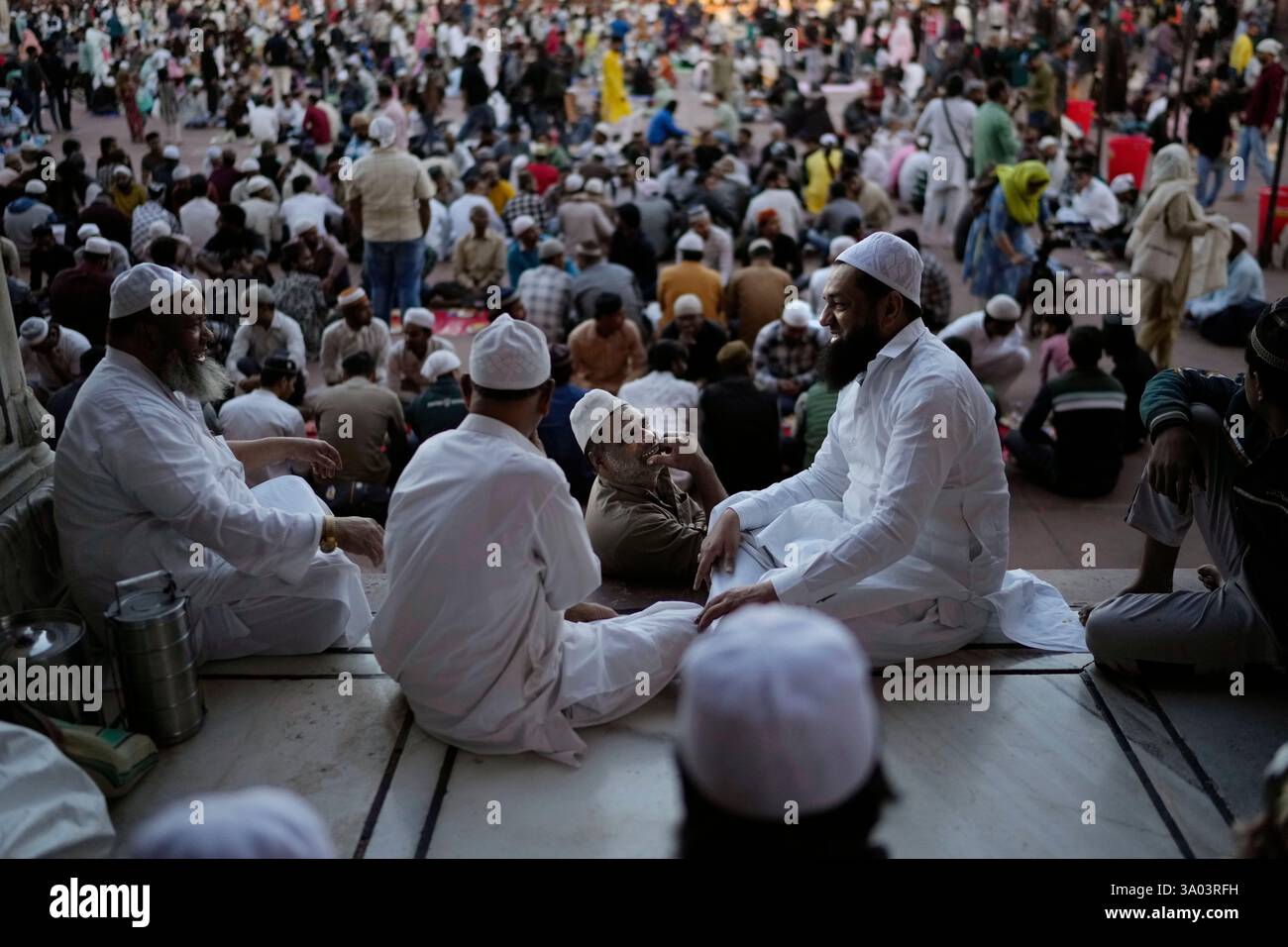Devout Muslims wait to break their fast on the first day of Ramadan at ...