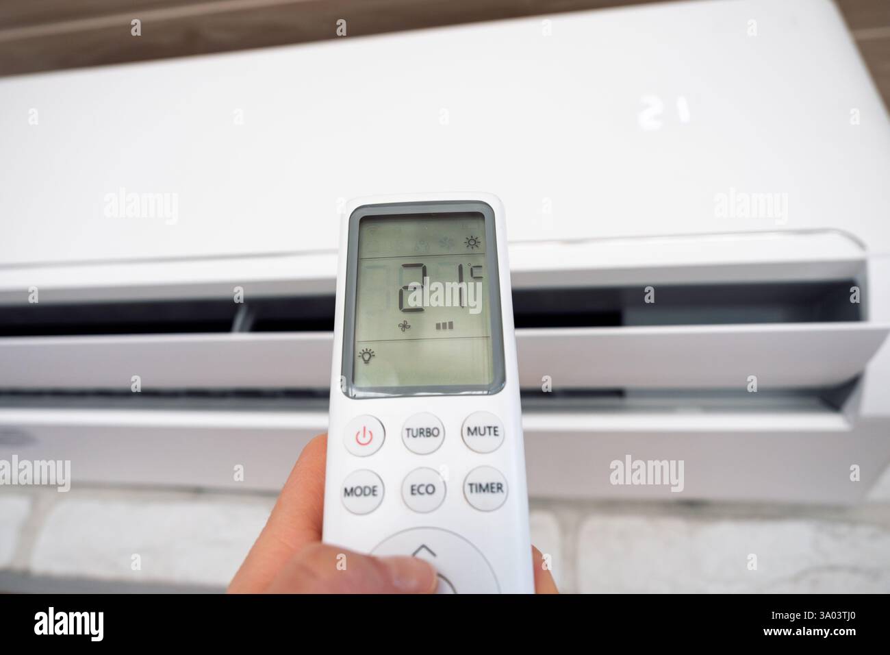 Close-up Of Hand Operating Air Conditioner With Remote Control Stock ...