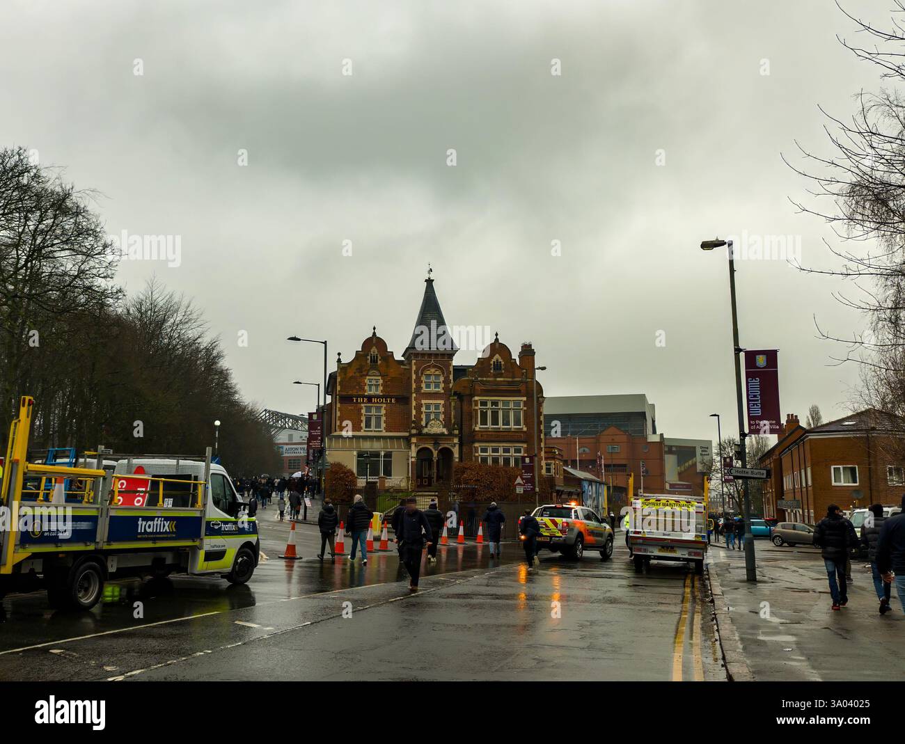 Supporters walking past the Holte Pub towards Villa Park in Birmingham, West Midlands, UK Stock Photo