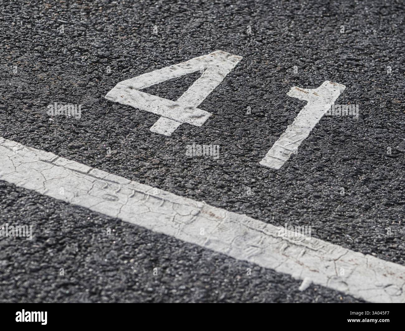 A bold number 41 is prominently displayed on the cracked asphalt ...
