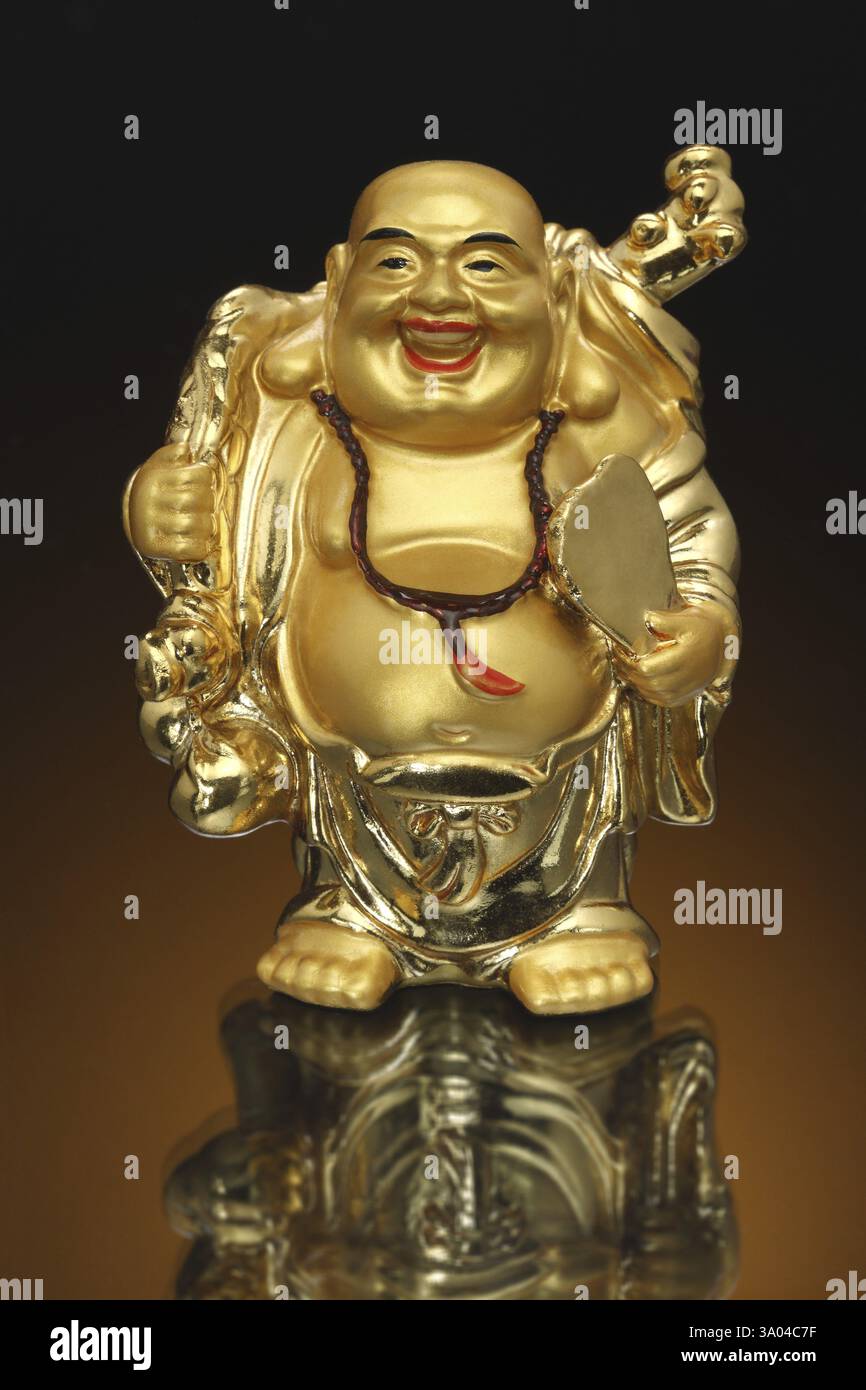 Golden laughing Buddha of feng shui, India, Asia Stock Photo