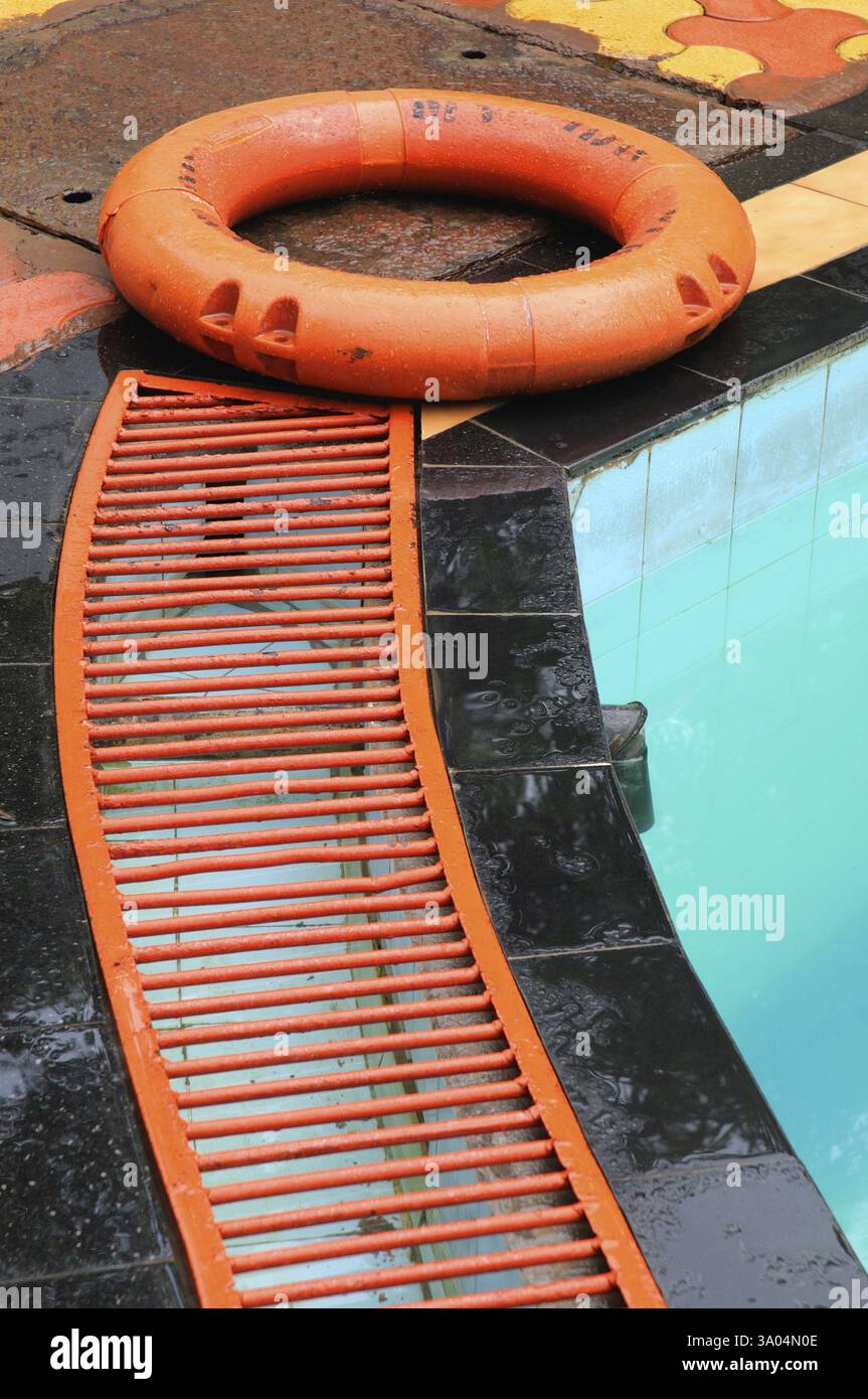 Rescue equipment lifeguard ring floating on iron grill of drain of ...