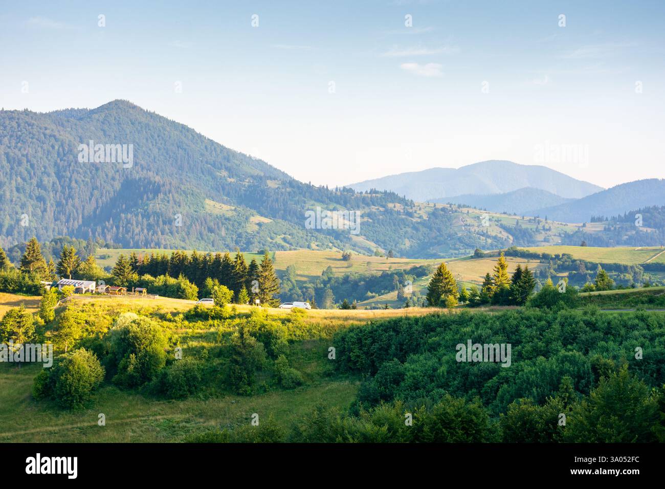 rural area of transcarpathia in summer. beautiful view. countryside scenery with rolling hills in morning light. carpathian mountain landscape of ukra Stock Photo
